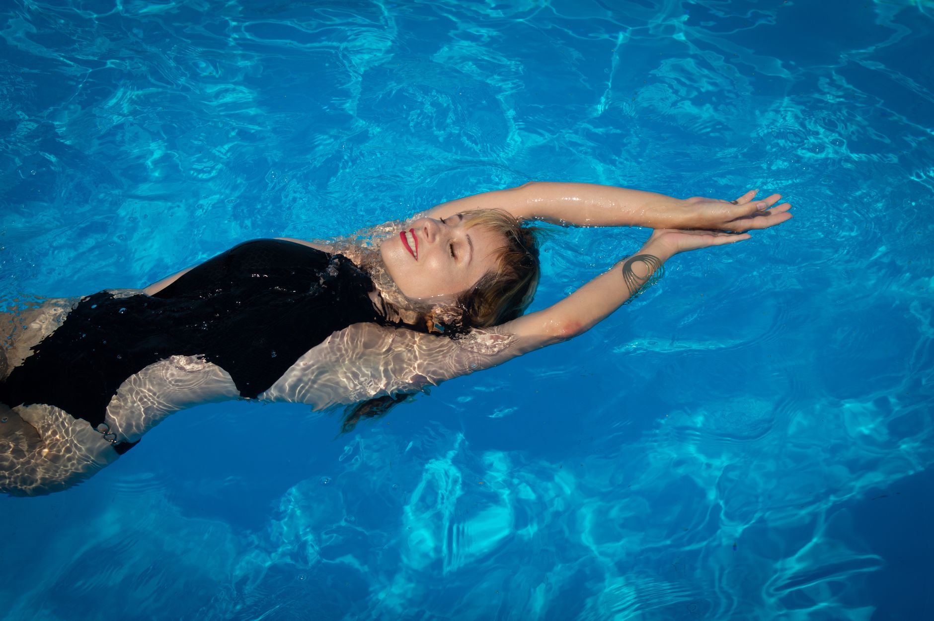 Femme en bikini au bord de la piscine